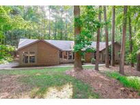 Charming brick home with beautiful surrounding trees offering shade and privacy at 11808 Black Horse Run, Raleigh, NC 27613