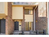 Charming two-story brick home with a covered entryway and large windows offering plenty of natural light at 1245 Schaub Dr, Raleigh, NC 27606
