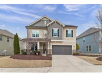 Inviting two-story home featuring a manicured lawn, neutral siding, and a two-car garage at 1715 Capstone Dr, Durham, NC 27713