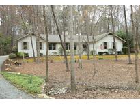 Charming single-story home featuring a painted brick exterior and mature landscaping at 21 Wedgewood Rd, Chapel Hill, NC 27514