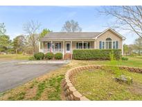 Charming single-story home with manicured front yard and inviting front porch and mature landscaping at 2782 N Shiloh Rd, Garner, NC 27529