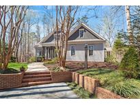 Charming home with landscaped yard, brick stairs, and craftsman style architectural details at 3120 A Timberlyne Dr, Mebane, NC 27302