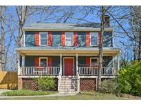 Charming two-story home featuring a welcoming front porch and a well-maintained yard at 4532 Draper Rd, Raleigh, NC 27616
