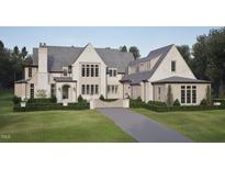 Charming exterior with a grey roof, a manicured lawn, and a private driveway at 4921 Foxridge Dr, Raleigh, NC 27614