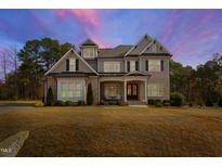 Charming two-story home with manicured landscaping and a mix of stone and siding, creating a welcoming curb appeal at 6108 Norwood Place Ct, Raleigh, NC 27613