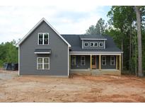 New construction home featuring gray siding, white framed windows, and a covered front porch at 65 Stream View Way, Spring Hope, NC 27882