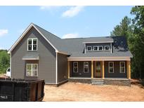 New home with gray siding, stone accents, and a covered front porch featuring wooden pillars at 65 Stream View Way, Spring Hope, NC 27882