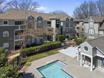 Inviting apartment complex featuring a pool, charming balconies, and lush landscaping offers a comfortable living environment at 1121 Parkridge Ln # 207, Raleigh, NC 27605