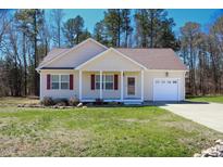 Charming single-Gathering home featuring a well-manicured lawn and attached one-car garage at 1220 E Middleton Dr, Creedmoor, NC 27522