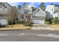 Charming two-story home features a welcoming front porch, well-manicured landscaping, and a two-car garage at 1720 Highpoint St, Wake Forest, NC 27587
