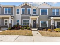 Charming two-story townhome with a landscaped front yard and inviting entrance at 1805 Kauri Cliffs Dr, Fuquay Varina, NC 27526