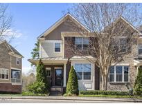 Beautiful brick and siding townhome with manicured landscaping on a sunny day at 3001 Valleystone Dr, Cary, NC 27519