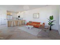 Bright and airy living room featuring an open-concept kitchen and stylish modern furnishings at 409 Alston St # 101, Raleigh, NC 27601