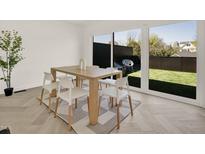 Bright dining room featuring modern furnishings, natural light, and views of a green backyard at 409 Alston St # 102, Raleigh, NC 27601