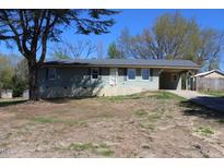 Inviting single-story home with light blue siding and a covered carport, nestled on a spacious lot at 5301 Daleview Dr, Raleigh, NC 27610