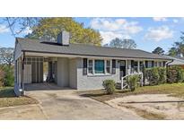 Charming single-story home featuring a carport, manicured front yard, and classic architectural details at 539 N Oneil St, Clayton, NC 27520