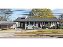 Charming single-story home featuring a grey brick facade, covered carport, and well-maintained front yard at 539 N Oneil St, Clayton, NC 27520