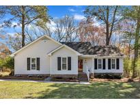 Charming one-story home featuring a well-manicured lawn and classic white siding with black shutter accents at 5508 Lake Garden Ct, Raleigh, NC 27610