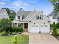 Charming home with a two-car garage, manicured lawn, and inviting front entrance at 5811 Shawood Dr, Raleigh, NC 27609