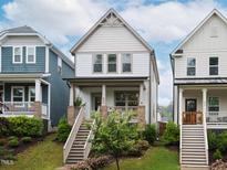 Charming two-story home featuring a welcoming front porch and well-maintained landscaping at 606 Great Ridge Pkwy, Chapel Hill, NC 27516