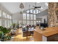 Bright living room featuring hardwood floors, floor to ceiling windows, and modern decor at 7917 Holly Springs Rd, Raleigh, NC 27606