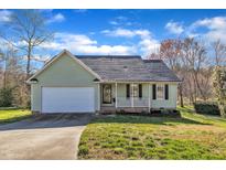 Charming single-story home with a two car garage and a welcoming front porch at 803 Trail Stream Way, Knightdale, NC 27545