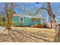 Charming bungalow with front porch, landscaped yard, and mature tree at 810 Cox Ave, Durham, NC 27701