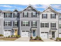 Charming townhomes featuring varied exteriors, attached garages, and meticulously maintained landscaping at 1107 Pale Moss Dr, Durham, NC 27704