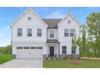 Charming two-story white home with a two-car garage, green grass, and a welcoming front entrance at 111 Silver Moon Ln # 121, Clayton, NC 27527