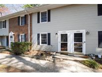 Inviting townhouse exteriors with well-maintained yards and brick and vinyl siding at 1248 Jamestown Ct, Cary, NC 27511