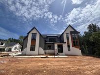 New two-story home features modern architectural design with gray and white painted brick at 170 Cherry Bark Dr, Youngsville, NC 27596