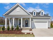 Charming single-Gathering home with gray siding, dormer windows, and a well-manicured front yard at 190 Salem Village Dr, Fuquay Varina, NC 27526