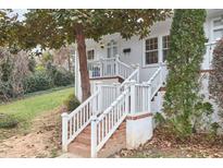 Charming front entrance with brick stairs, white railings, and a well-kept lawn at 1921 Clark Ave # 105, Raleigh, NC 27605