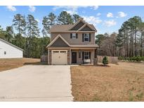 Charming two-story home with a one-car garage, manicured lawn, and inviting front porch at 20 W Park Ln, Sanford, NC 27332