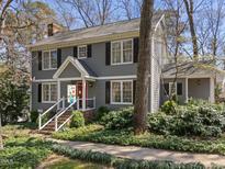 Charming two-story home with gray siding, black shutters, front porch, and landscaped yard at 2005 Bridgeport Dr, Raleigh, NC 27615