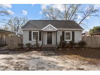 Charming home featuring a well-manicured front yard and a covered carport at 211 W Sycamore, Zebulon, NC 27597