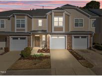 Charming townhome with stone accents, two-car garage, and cozy front porch in a desirable community at 2523 Spring Oaks Way, Raleigh, NC 27614