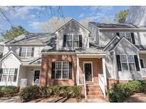 Charming townhouse with brick facade, gray siding, black shutters, and well-maintained front landscaping at 2608 Broad Oaks Pl, Raleigh, NC 27603