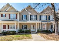 Inviting townhome with covered porch and well-maintained landscaping, creating a welcoming entrance at 4011 Volkswalk Pl, Raleigh, NC 27610