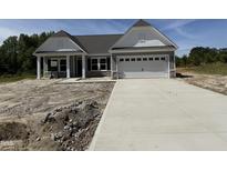 New construction home with a gray exterior, white trim, and a concrete driveway at 4013 Kingcraig Ln, Zebulon, NC 27597