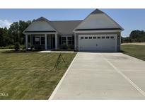 Charming single-Gathering home with a well-manicured lawn and a spacious two-car garage at 4013 Kingcraig Ln, Zebulon, NC 27597