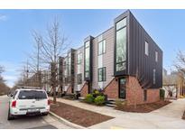 Modern townhomes boast a contemporary design with brick and metal exteriors and large, prominent windows at 402 Chavis Way, Raleigh, NC 27601