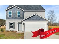 Charming two-story home featuring a two-car garage, stylish gray siding and a manicured front lawn at 41 Alderman Ct # 2, Dunn, NC 28334