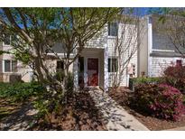 Charming exterior featuring a well-maintained facade, inviting entryway, and lush landscaping at 4633 Edwards Mill Rd, Raleigh, NC 27612