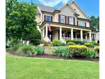 Charming two-story home with a welcoming front porch and beautifully landscaped front yard at 512 Hallburg Ct, Wake Forest, NC 27587