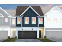 New construction townhouse with a two-car garage, dark-blue siding, and manicured landscaping at 6019 Enclosure Way, Durham, NC 27703