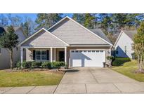 Charming single-story home with a well-manicured lawn and a two-car garage at 626 Flaherty Ave, Wake Forest, NC 27587