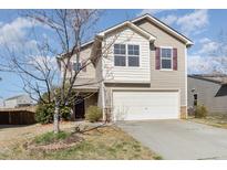 Two-story home featuring beige siding, maroon shutters, and a two-car garage at 627 Hastings Rd, Mebane, NC 27302