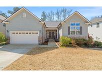Charming single-Gathering home with a two-car garage and inviting front yard at 7652 Channery Way, Raleigh, NC 27616