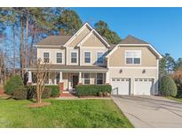Charming two-story home with a manicured front yard and a two-car garage offers great curb appeal at 9 Water Stone Ct, Durham, NC 27705